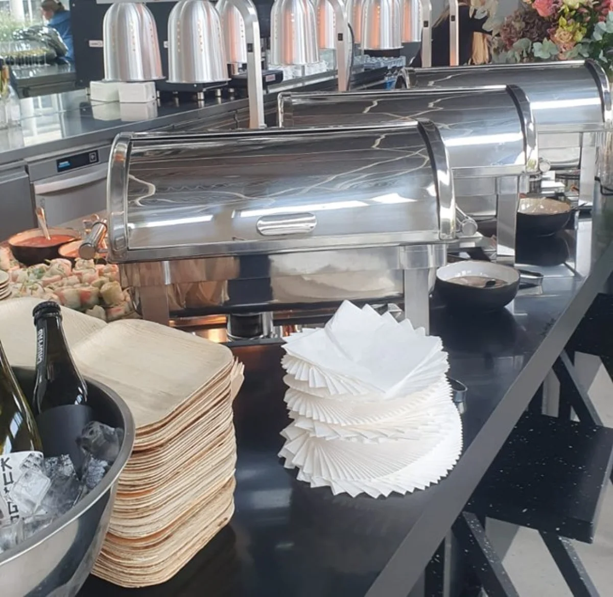 Professional catering buffet setup with stainless steel chafing dishes and serving station for events